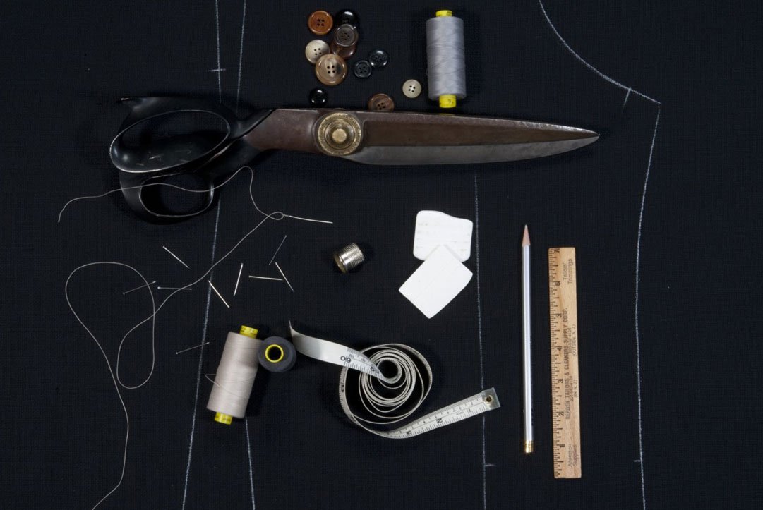 Master tailor hand-sewing full-canvas luxury Italian suit jacket using traditional Neapolitan techniques at DELETTO Binghamton atelier – bespoke tailoring New York State